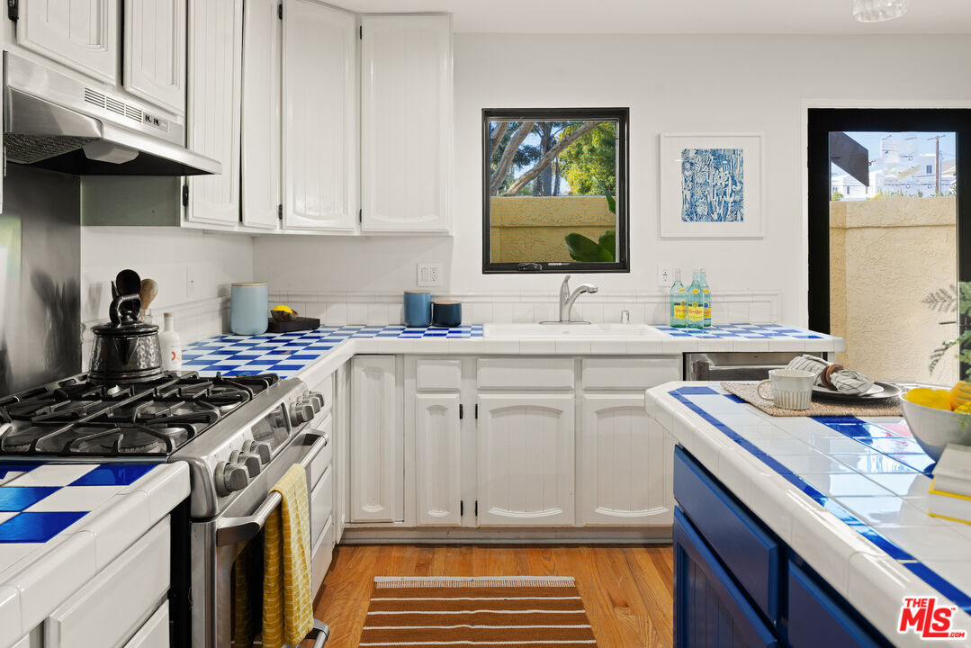 2613 5th Street Santa Monica, CA 90405 - Photo 7 of 30 a kitchen with a sink stove and cabinets