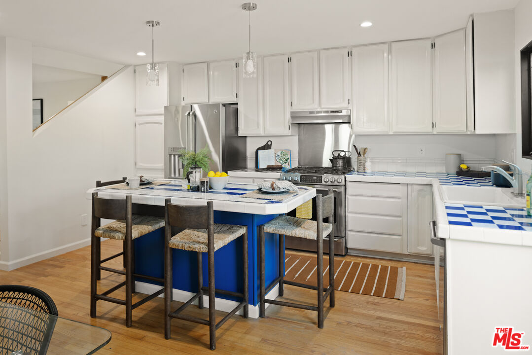 2613 5th Street Santa Monica, CA 90405 - Photo 8 of 30 a kitchen with a dining table chairs and refrigerator