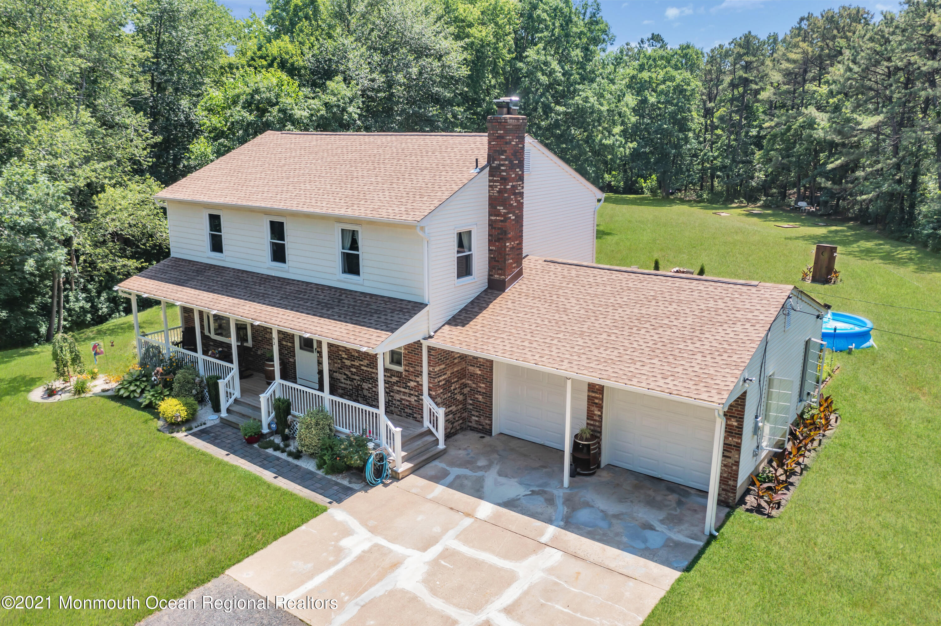 an aerial view of a house with a yard table and chairs