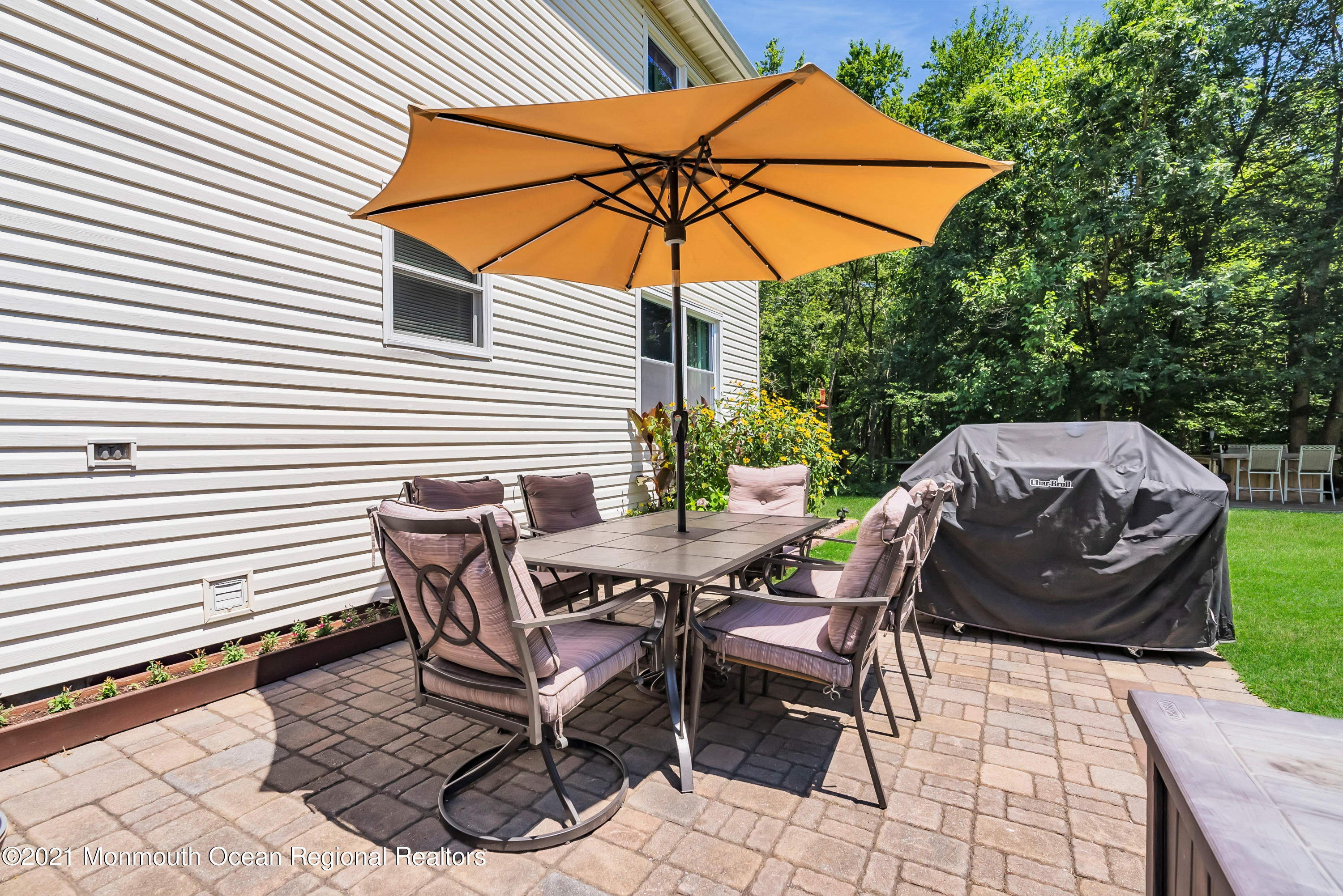 93 Jackson Mills Road Jackson, NJ 08527 - Photo 34 of 39 a view of a patio with table and chairs under an umbrella