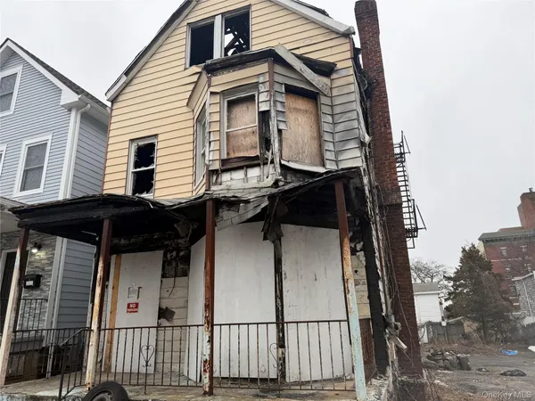 a view of a house with a wooden fence