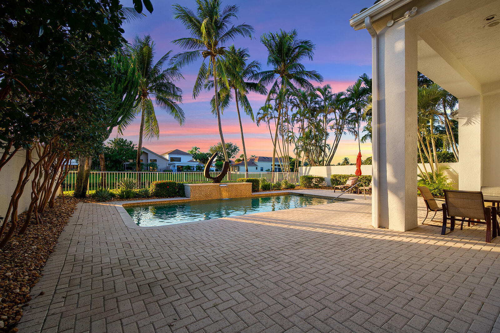 17051 Grand Bay Drive Boca Raton, FL 33496 - Photo 20 of 91 a view of a swimming pool with a table and chairs