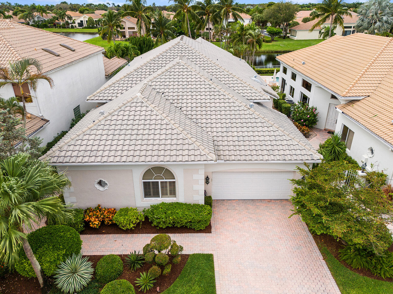 17051 Grand Bay Drive Boca Raton, FL 33496 - Photo 39 of 91 a view of a white house with a yard and potted plants