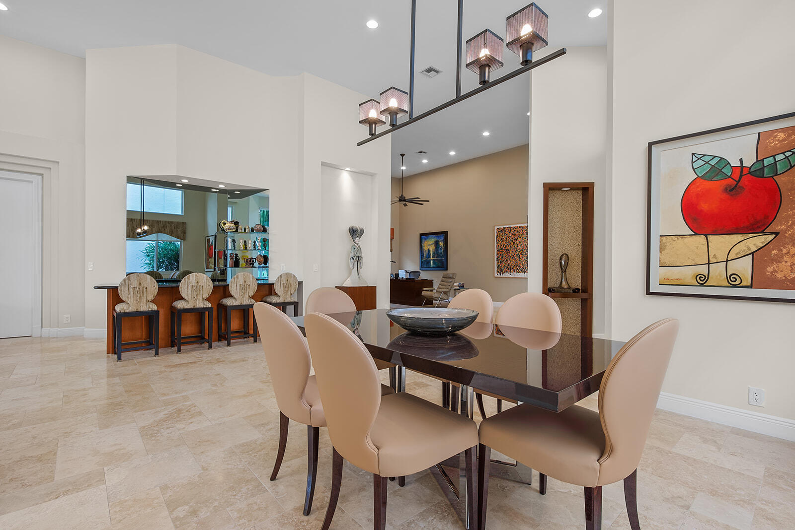 17051 Grand Bay Drive Boca Raton, FL 33496 - Photo 76 of 91 a view of a dining room and livingroom with furniture a rug a potted plant and a fireplace