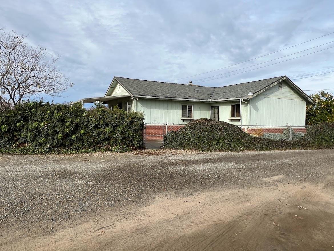 16109 East Manning Reedley, CA 93654 - Photo 2 of 30 a front view of a house with a yard and garage