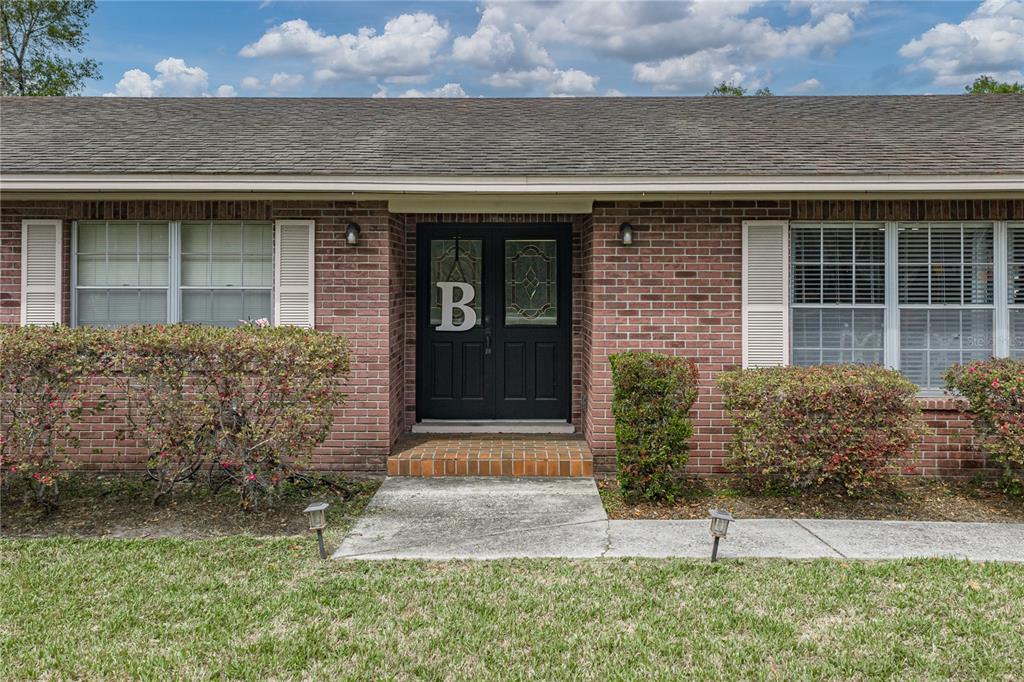 609 West Pipkin Road Lakeland, FL 33813 - Photo 8 of 72 front view of a brick house with a yard