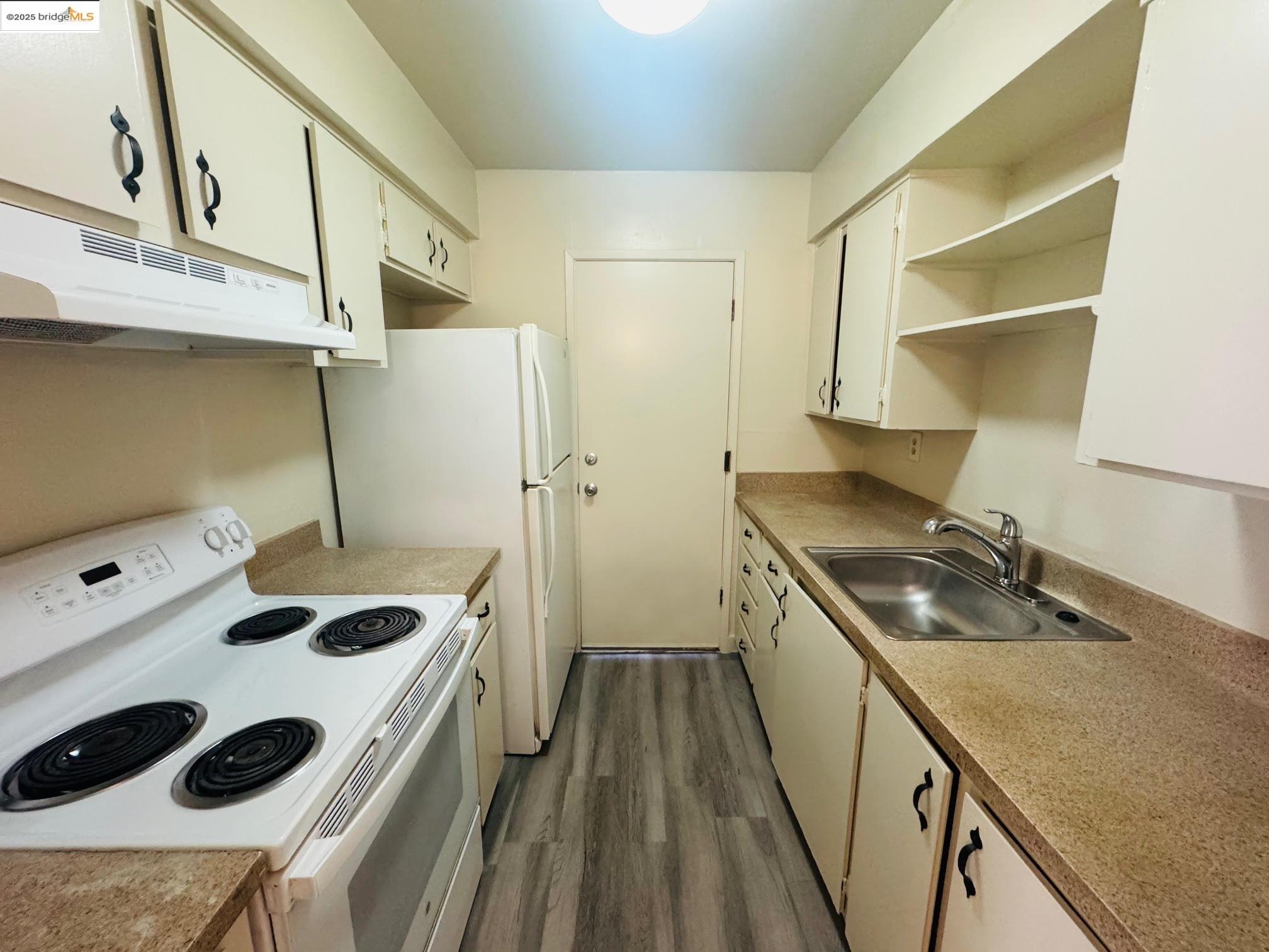 1459 Del Rio Circle, Unit C Concord, CA 94518 - Photo 5 of 9 a kitchen with a sink a stove and refrigerator