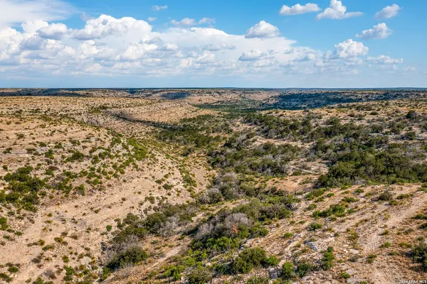 an aerial view of residential houses with city view