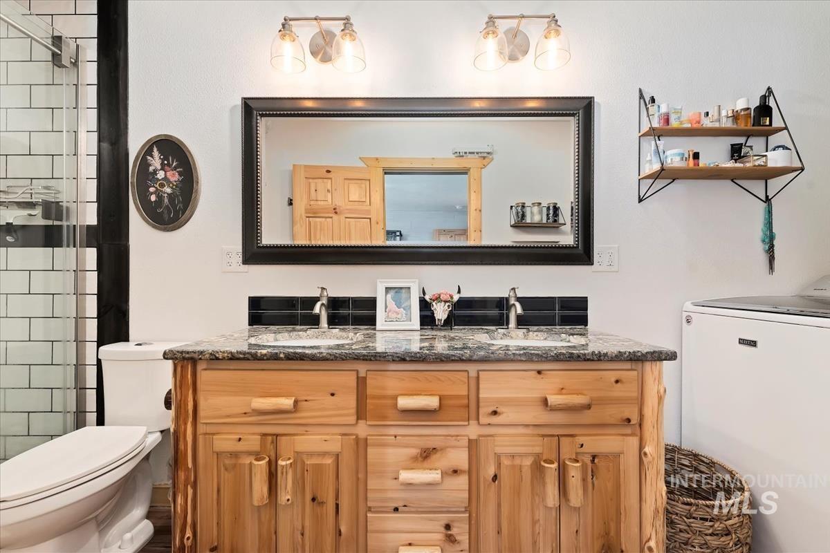3 Boone Road Garden Valley, ID 83622 - Photo 16 of 49 Vaulted ceiling with wood paneling, full-height windows, wood-finish flooring, and a large multi-bulb chandelier