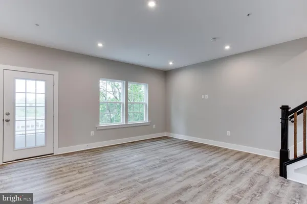 a kitchen with stainless steel appliances granite countertop a sink a stove a refrigerator and island