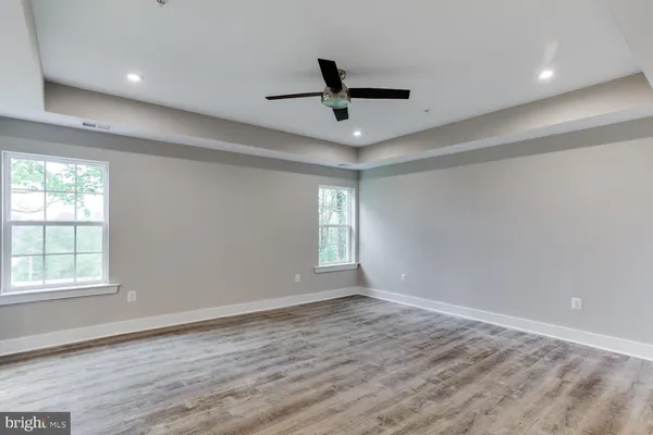 a view of an empty room and wooden floor