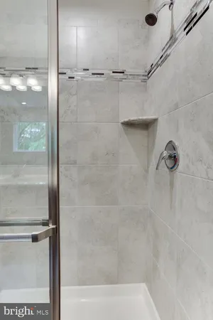 a bathroom with a bathtub shower sink vanity and toilet