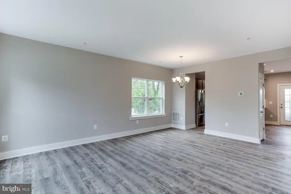 a view of a livingroom with wooden floor and workspace