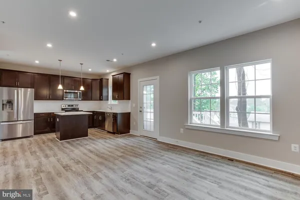 a view of kitchen with stove and wooden floor