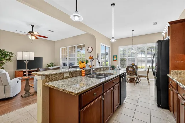 a kitchen with a stove center island and living room view