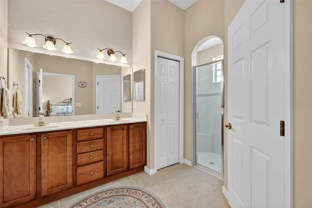 a spacious bathroom with a double vanity sink and a mirror