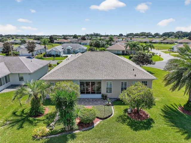 an aerial view of a house with yard swimming pool and outdoor seating