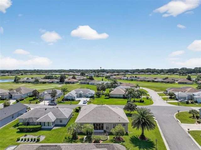 an aerial view of a house with yard swimming pool and outdoor seating