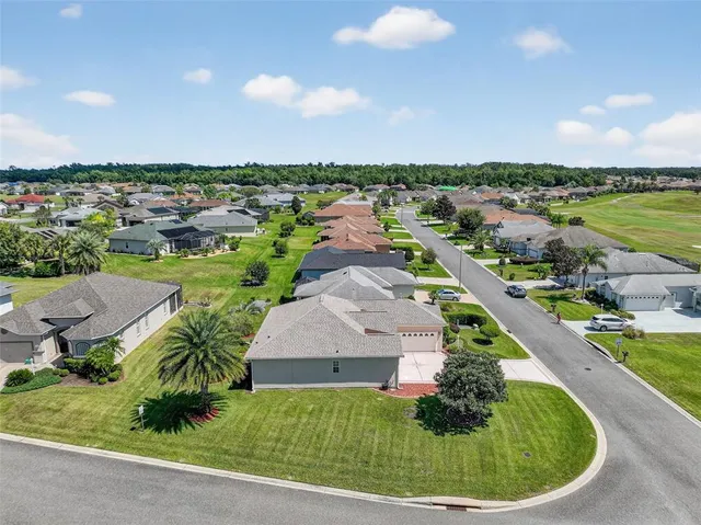 an aerial view of a house with a garden and trees