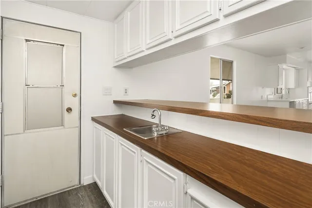 a kitchen with granite countertop a sink and cabinets
