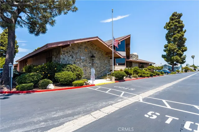 a front view of a house with a yard and potted plants
