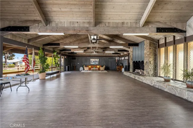 a view of a water heater room with wooden floor