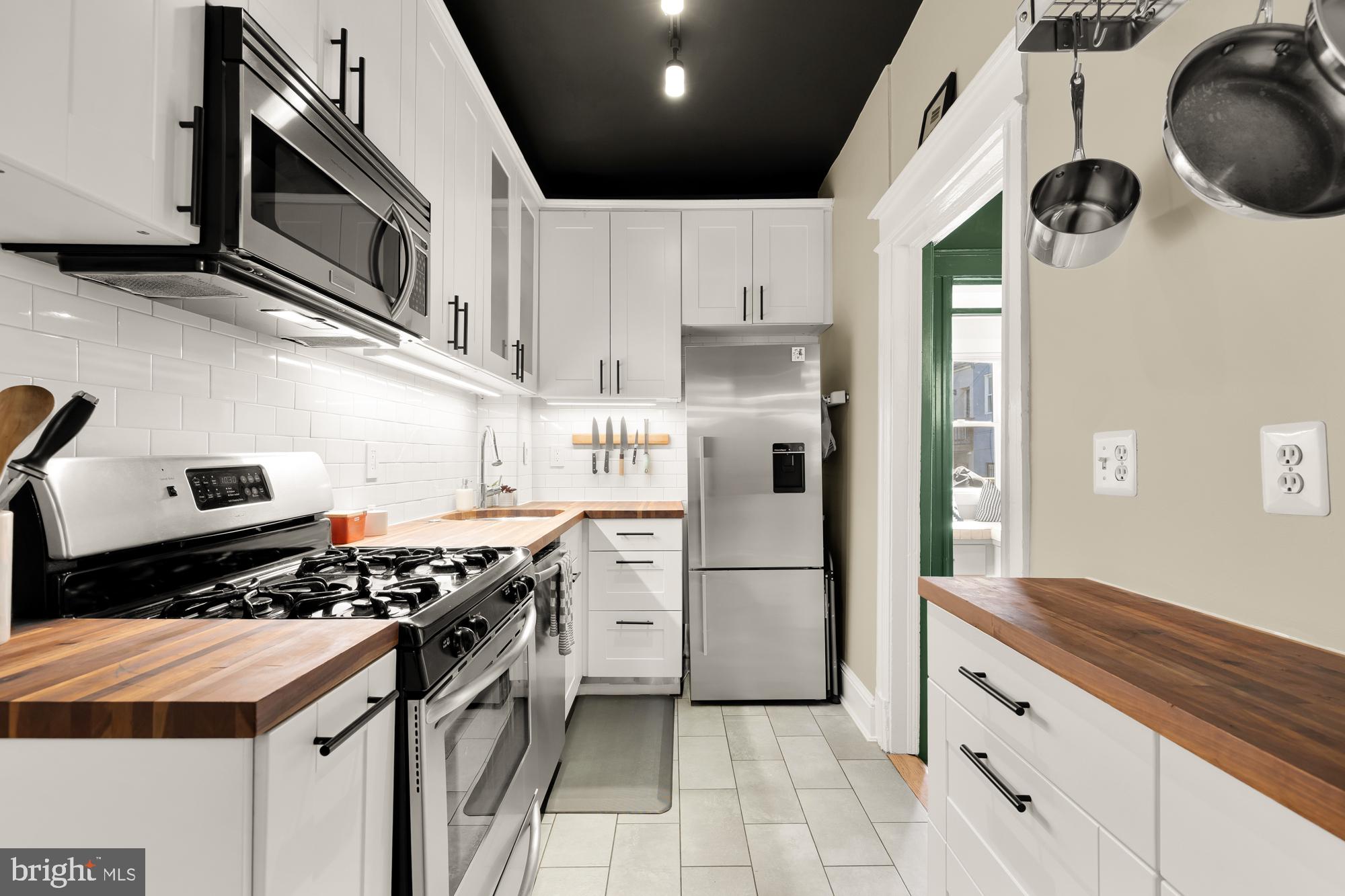 1109 7th Street Northeast Washington, DC 20002 - Photo 11 of 32 a kitchen with stainless steel appliances a stove a sink and a refrigerator