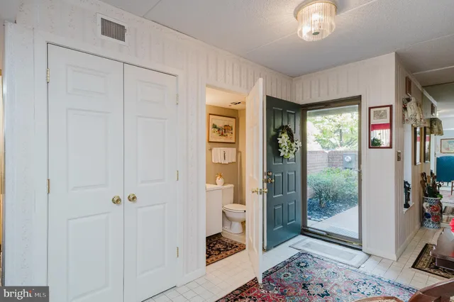 a view of a hallway with wooden floor and a bedroom