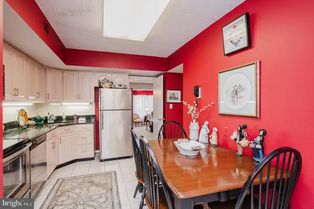 a kitchen with stainless steel appliances granite countertop a stove a sink dishwasher and cabinets with wooden floor
