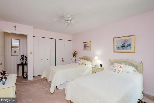 a bedroom with two bed and a large mirror