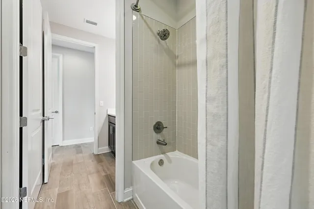 a bathroom with a bathtub and a shower