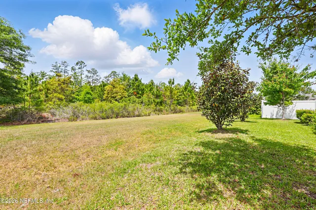 a view of yard with swimming pool and green space