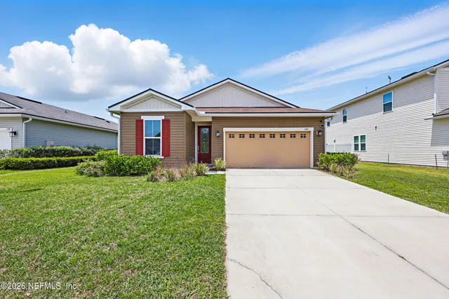 a front view of a house with a yard and garage