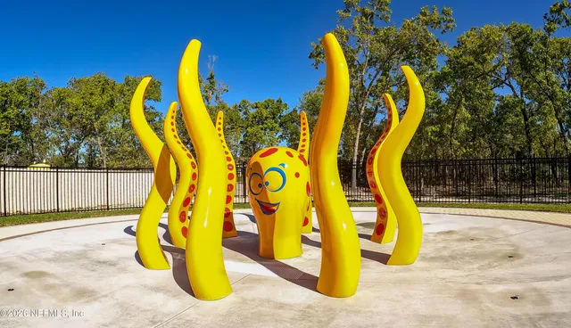 a view of a park with iron fence