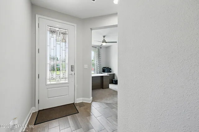 a view of a hallway with a bedroom and a window
