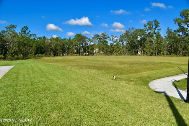 an aerial view of a house with a garden and lake view