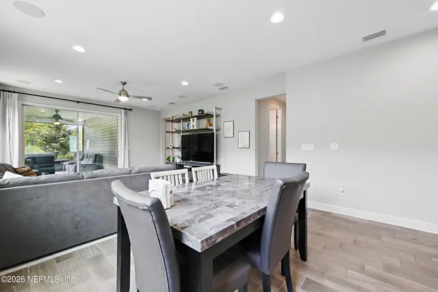 a dining room with furniture and window