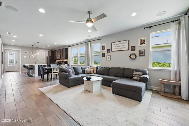 a living room with furniture and kitchen view
