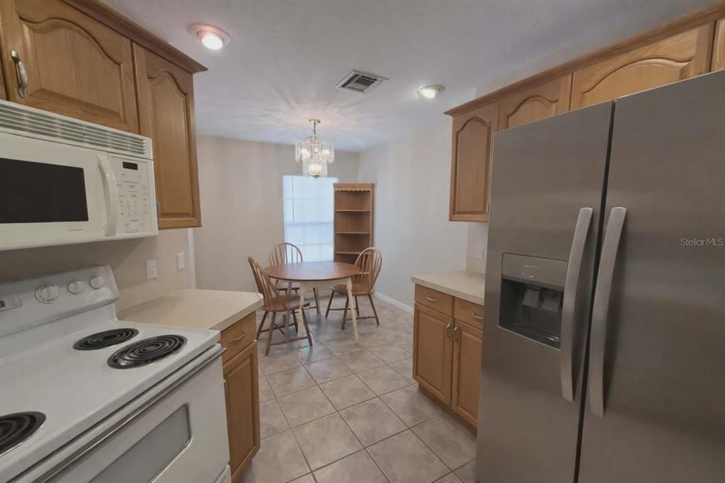 14396 Southwest 19th Place Ocala, FL 34481 - Photo 3 of 10 a kitchen with stainless steel appliances granite countertop a refrigerator and a stove top oven