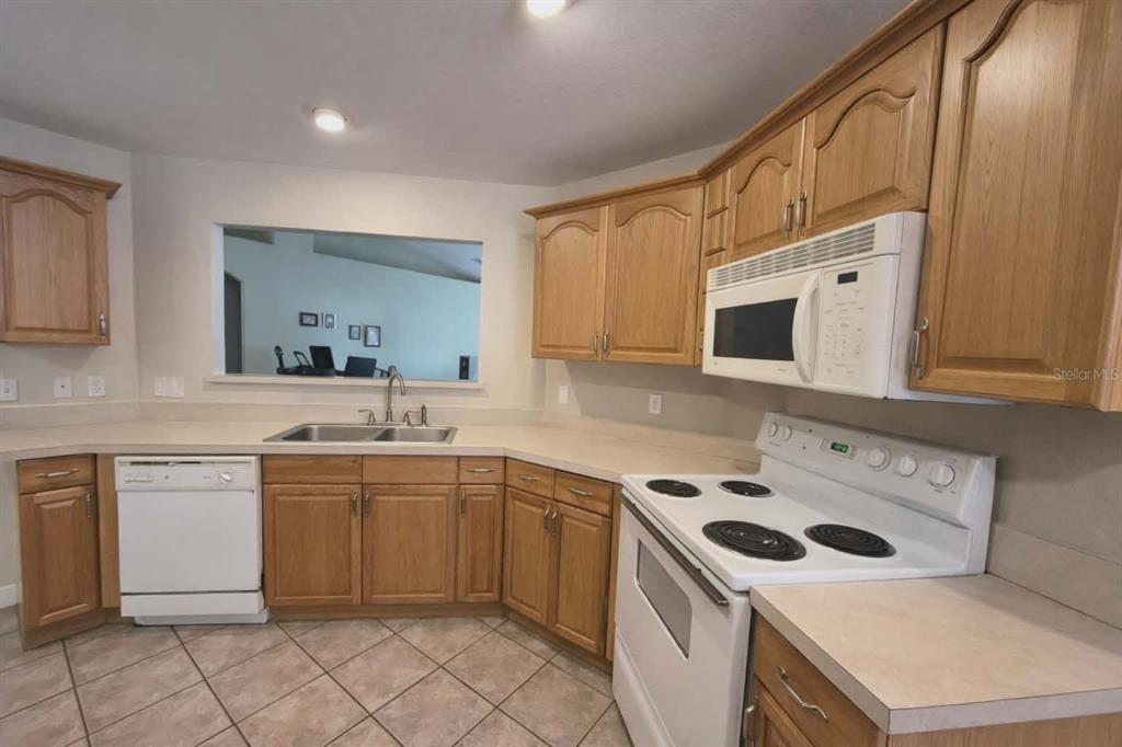 14396 Southwest 19th Place Ocala, FL 34481 - Photo 4 of 10 a kitchen with a sink a stove and cabinets