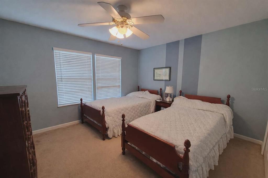 14396 Southwest 19th Place Ocala, FL 34481 - Photo 7 of 10 a bedroom with two beds and a chandelier