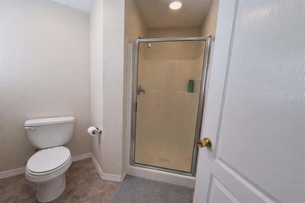 14396 Southwest 19th Place Ocala, FL 34481 - Photo 10 of 10 a bathroom with a granite countertop toilet and a shower