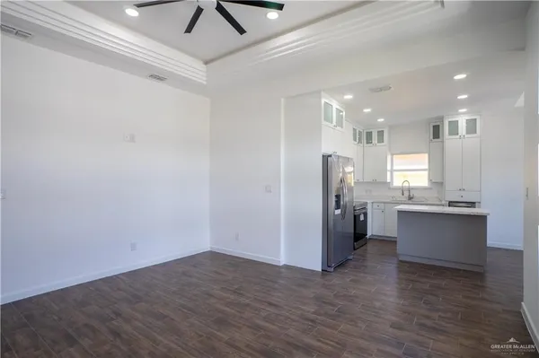 a view of kitchen with stainless steel appliances refrigerator microwave and stove