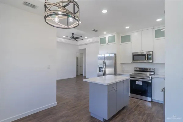 a kitchen with stainless steel appliances a sink stove and refrigerator