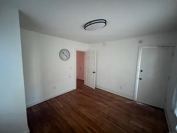 a view of a room with wooden floor