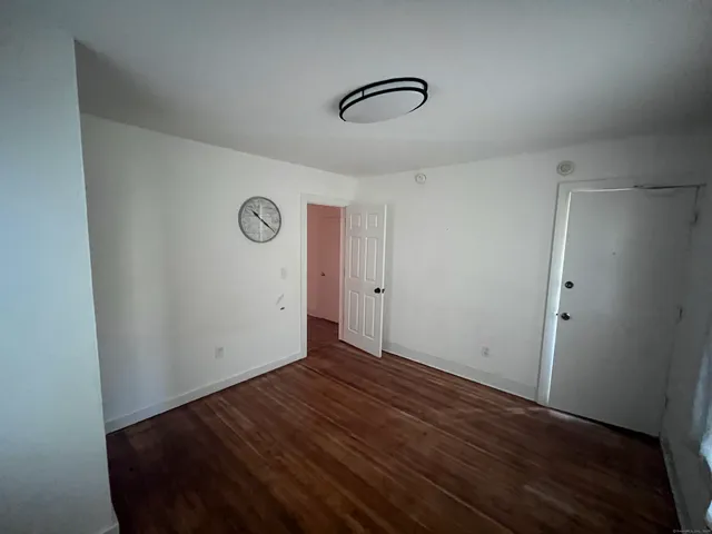 a view of a room with wooden floor
