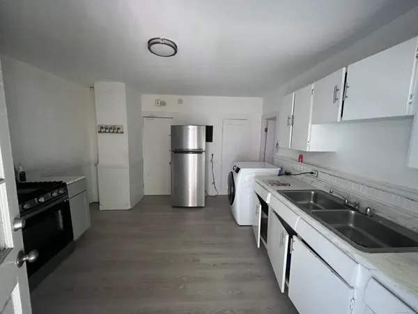 a kitchen with a sink stove and refrigerator