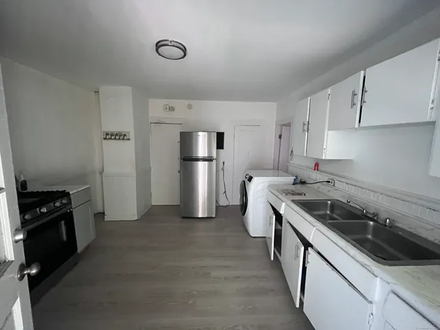 a kitchen with a sink stove and refrigerator