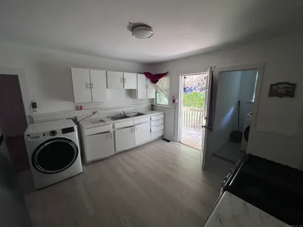 a view of a kitchen with sink washer and dryer