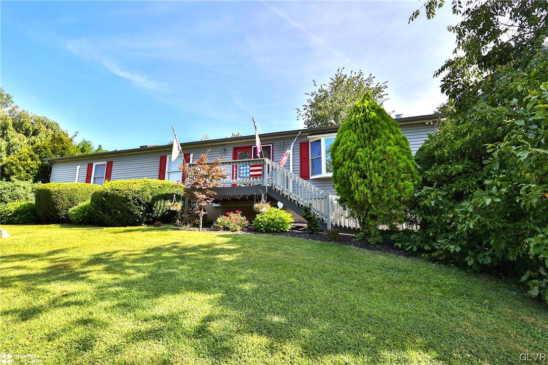 a view of a house with a yard and garage